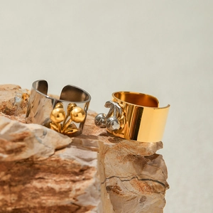 Two-tone 18k gold and silver stainless steel cherry heart open rings on natural stone