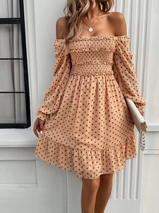 Detail of off-the-shoulder long sleeve mini dress with beige polka dot and ruffle hem