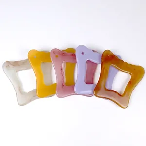 Five colored resin gua sha scraping boards for facial and body massage in marble textures