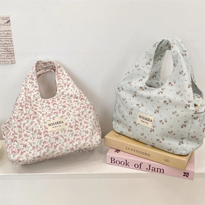 Close-up of floral canvas lunch bags with SOZAKKA woven labels and rustic patterns