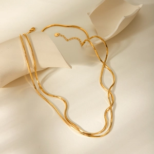 Double-layered 18K gold titanium steel snake chain necklace for women on white stones