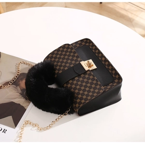 Detail of vintage square bag with floral print, faux fur handle and gold chain strap