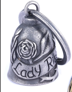 Detailed view of silver bell pendant with engraved roses and Lady Ride lettering