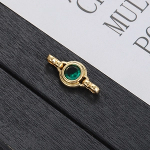 Macro shot of gold-plated circular green zircon connector link for jewelry DIY
