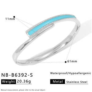 Detailed view of silver stainless steel bangle with light blue enamel and 61mm diameter