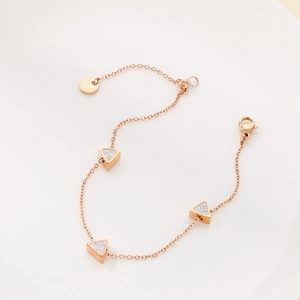 Elegant rose gold bracelet featuring three triangle pendants with sparkling crystal inlay