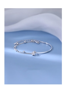 Detailed view of silver star pendant bracelet with double layered beads and curved bar