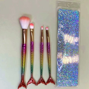 Detail of mermaid tail makeup brushes with gradient plating and holographic glitter pouch