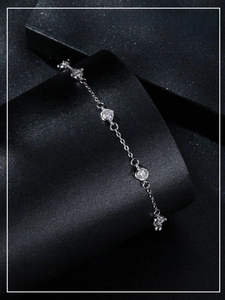 Close-up of elegant S925 sterling silver moissanite bracelet on a black display stand