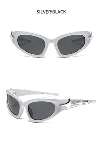 Detail view of silver Y2K cyberpunk sunglasses with black lenses and spike-shaped temple decor