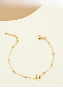 Detail of gold titanium steel star flower bracelet with zircon inlay and lobster clasp