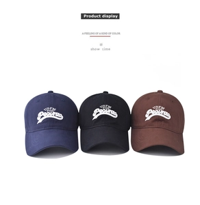 Detailed view of three baseball caps in navy, black, and brown with 3D letter embroidery