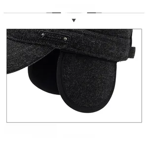 Detail of dark grey winter flat cap featuring ear flaps and Narason metal logo
