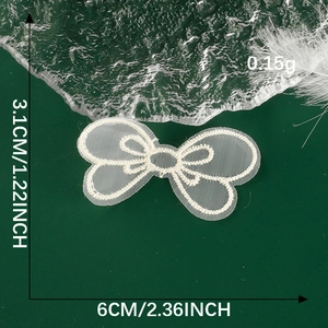 Detailed size view of white embroidered bow lace patch measuring 6cm by 3.1cm for DIY sewing