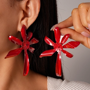 Detailed view of bold red layered flower earrings with a glossy metallic lacquer finish