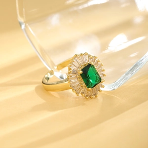Adjustable 18K gold plated ring with emerald green stone and baguette zircon accents