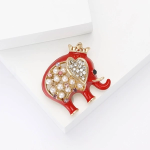 Red enamel elephant brooch with pearls and crystals on a clean white display stand