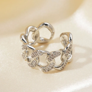 Close-up of silver adjustable chain ring with micro-pave zircons on beige silk