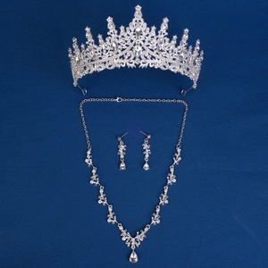 Detail of silver bridal jewelry set with sparkling rhinestones and floral crown design