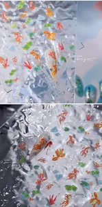 Close-up of 3D goldfish and lotus leaf nail stickers with laser iridescent textures