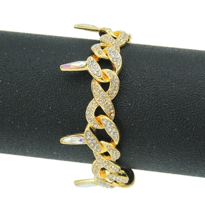 Gold-plated Cuban link bracelet with iced-out rhinestones and punk spike accents on stand