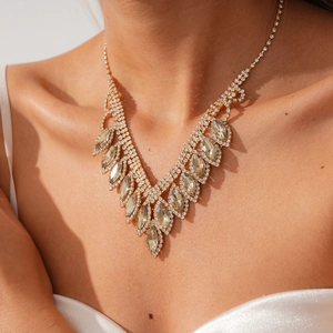 Close-up of golden marquise-cut crystal necklace with brilliant sparkle in natural light