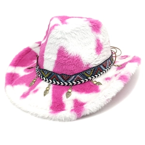 Detail of pink cow print plush cowboy hat with ethnic ribbon and metallic charms