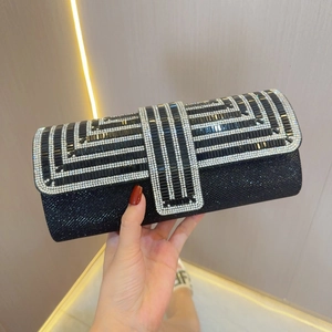 Detail of elegant black evening clutch featuring sparkling sequins and geometric rhinestones