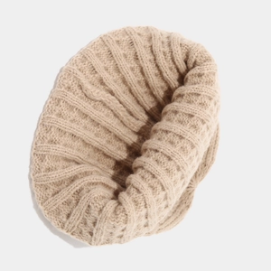 Beige chunky cable knit dockers cap with thick ribbed texture for autumn and winter