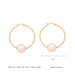 Detail showing 4.5cm stainless steel gold hoop earrings with white plastic pearls