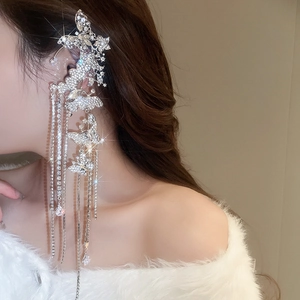 Detail of silver butterfly ear cuff with sparkling rhinestone tassels on a model
