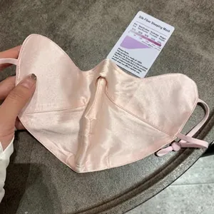 Breathable silk sun mask with eye corner protection and adjustable ear loops in soft pink