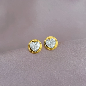 Gold round heart stud earrings with sparkling pavé crystals on lavender background