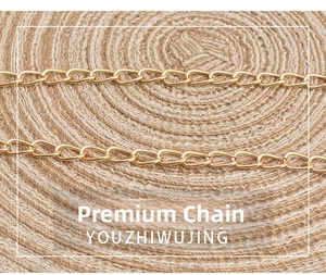 Close-up of high-quality gold metal chain strap on a vintage quilted square crossbody bag