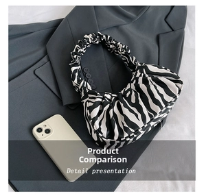 Zebra print ruched cloud bag shown next to a smartphone for detailed size comparison