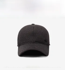 Detailed view of thick wool blend baseball cap fabric with a small metal ornament