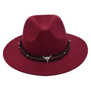 Detail of dark red fedora hat with bull skull buckle and studded leather band