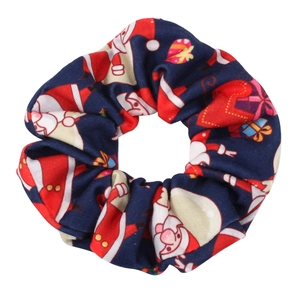 Detailed view of navy blue Christmas scrunchie with Santa Claus and gift box patterns