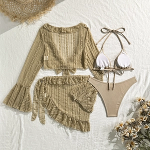 Detailed view of sand-colored bikini with ruffled sleeve cover-up and textured fabric