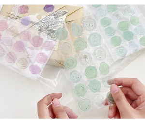 Translucent resin wax seal stickers in purple and green on vintage envelopes