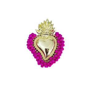 Detailed view of handmade beaded heart pendant with golden crown and pink bead trim