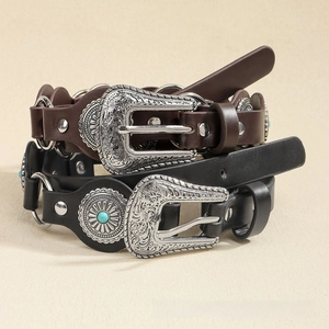 Detail of vintage punk belts with turquoise studs and engraved bohemian silver buckles