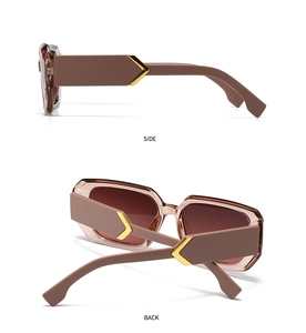 Detail view of square sunglasses with golden V-shaped logo and vintage brown frame