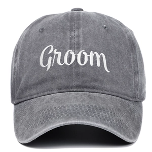 Detail of white Groom embroidery on washed dark grey denim cotton baseball cap