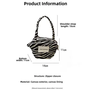 Detailed dimensions of the zebra pattern canvas handbag featuring a secure zipper closure