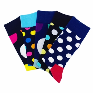 Macro view of five-pack knit crew socks with colorful polka dot and geometric patterns