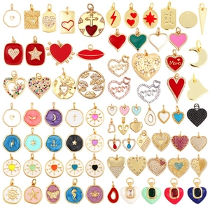 Flat lay of colorful enamel and rhinestone charms in heart and star shapes for DIY jewelry