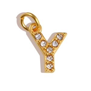 Macro shot of gold-plated letter Y pendant with sparkling white cubic zirconia stones