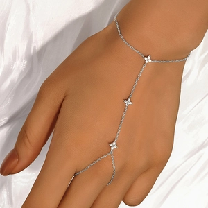 Detail of S925 silver hand harness with clover motifs and zircon stones on a model