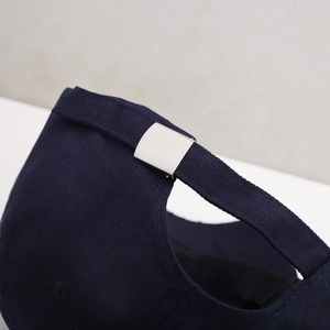 Navy blue baseball cap with adjustable silver metal slide buckle and cotton twill fabric